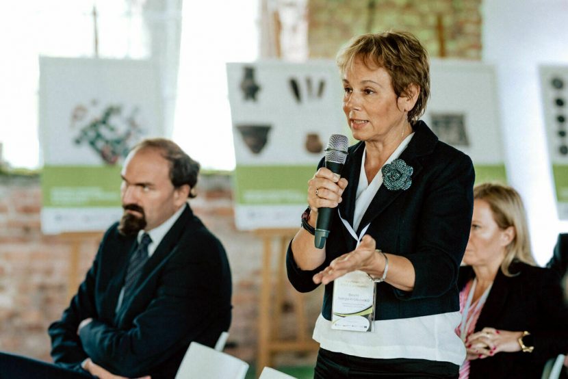 A woman asking a question at a conference