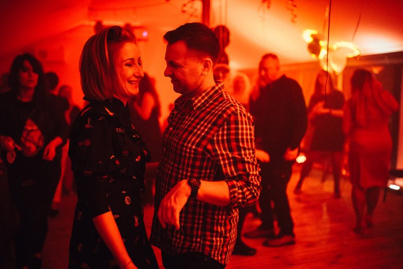 Couple on the dance floor in a red light