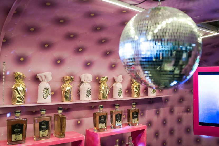 Pink interior with whiskey bottles and disco ball