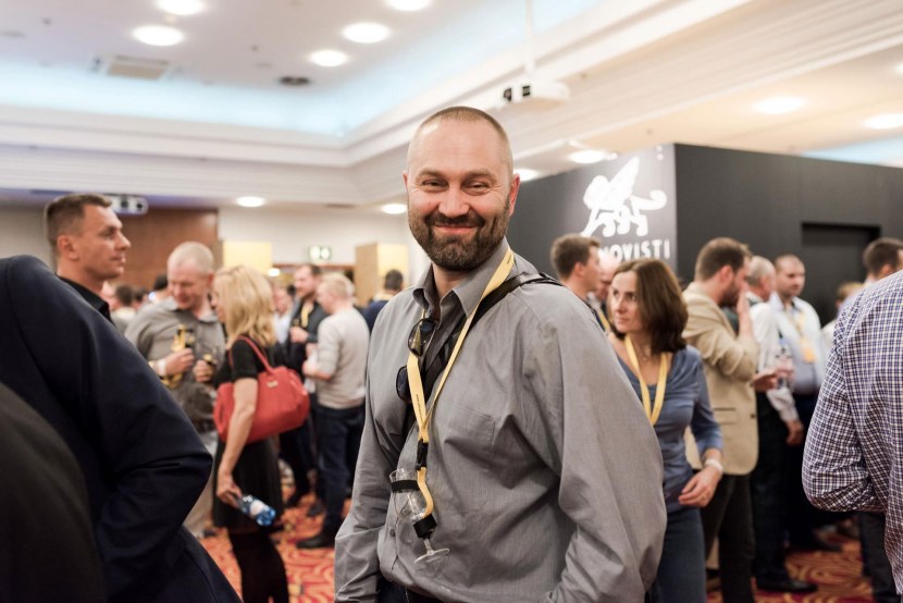 Smiling man with a beard and a glass around his neck during whisky Live Warsaw 2016